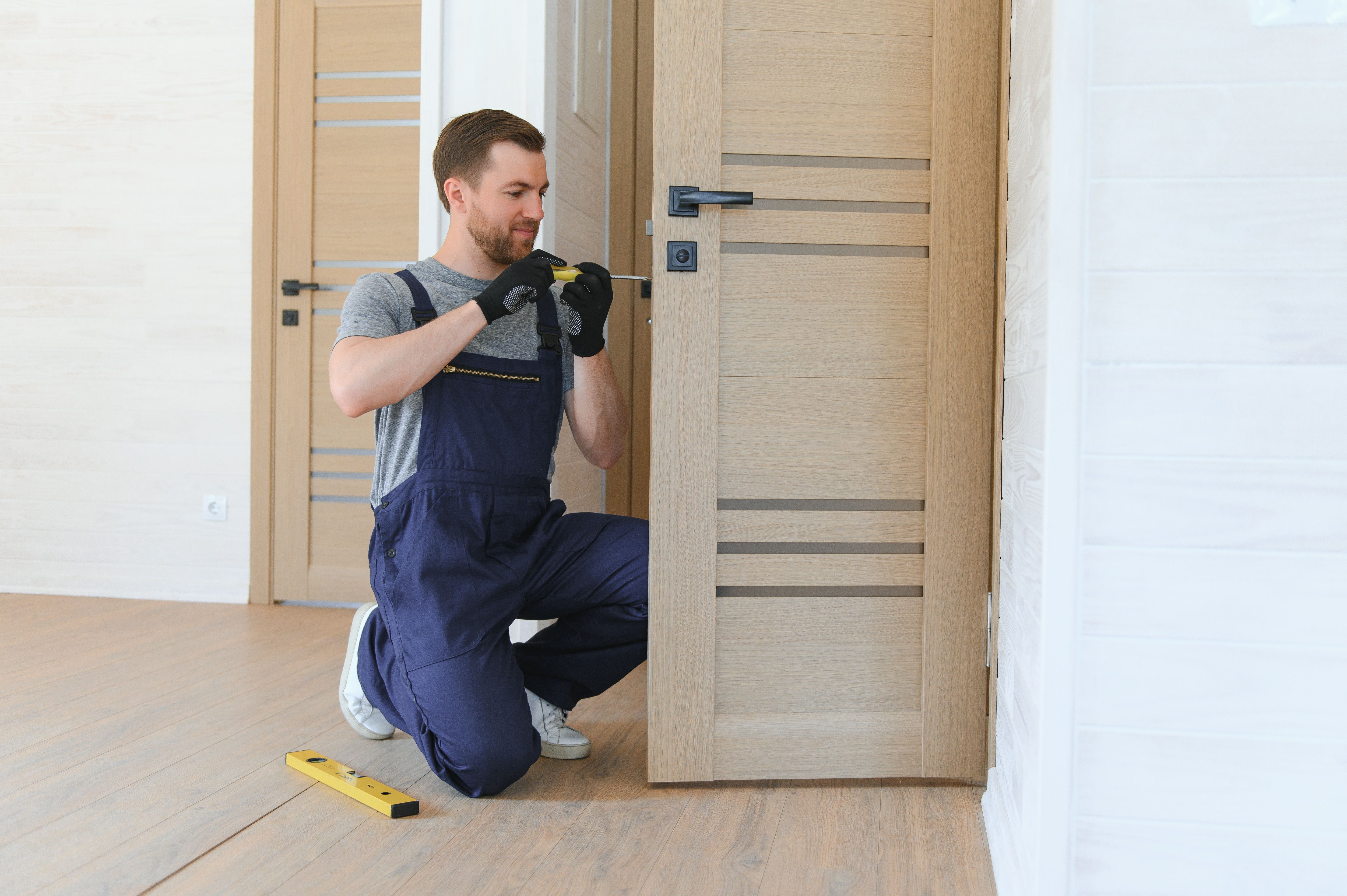 Installer adjusting a door for smooth operation.