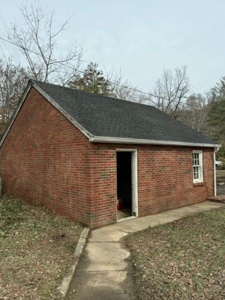 Residential home exterior during painting prep and masking.
