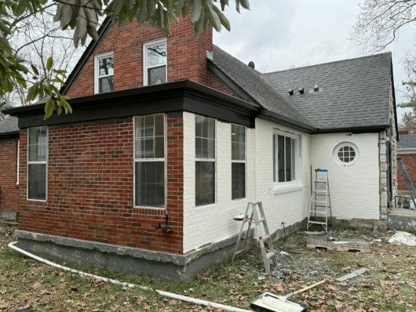 Painter access setup along a residential exterior.