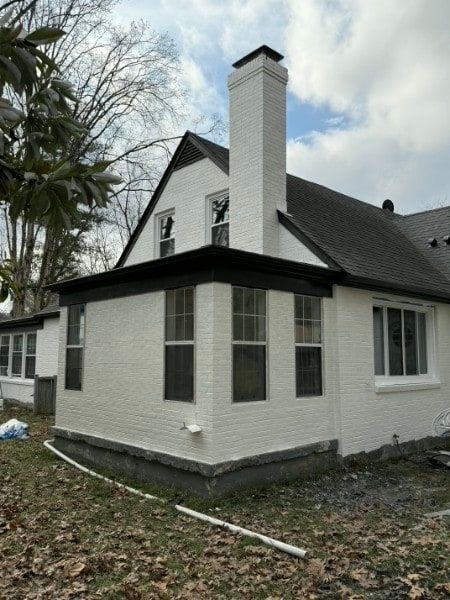 Window and trim during exterior house painting.